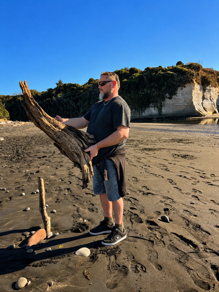 Dallas Corp collecting driftwood on the Taranaki coast